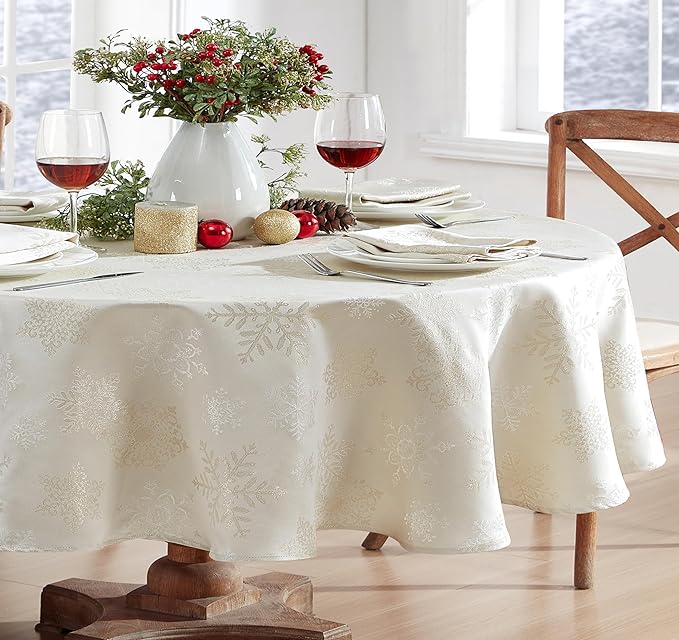 Newbridge Fancy Metallic Snowflake Christmas Fabric Tablecloth, 60 x 84 Inch Oval, Ivory Gold, No-Iron Soil Resistant Sparkling Snowflakes Woven Holiday Table Cover